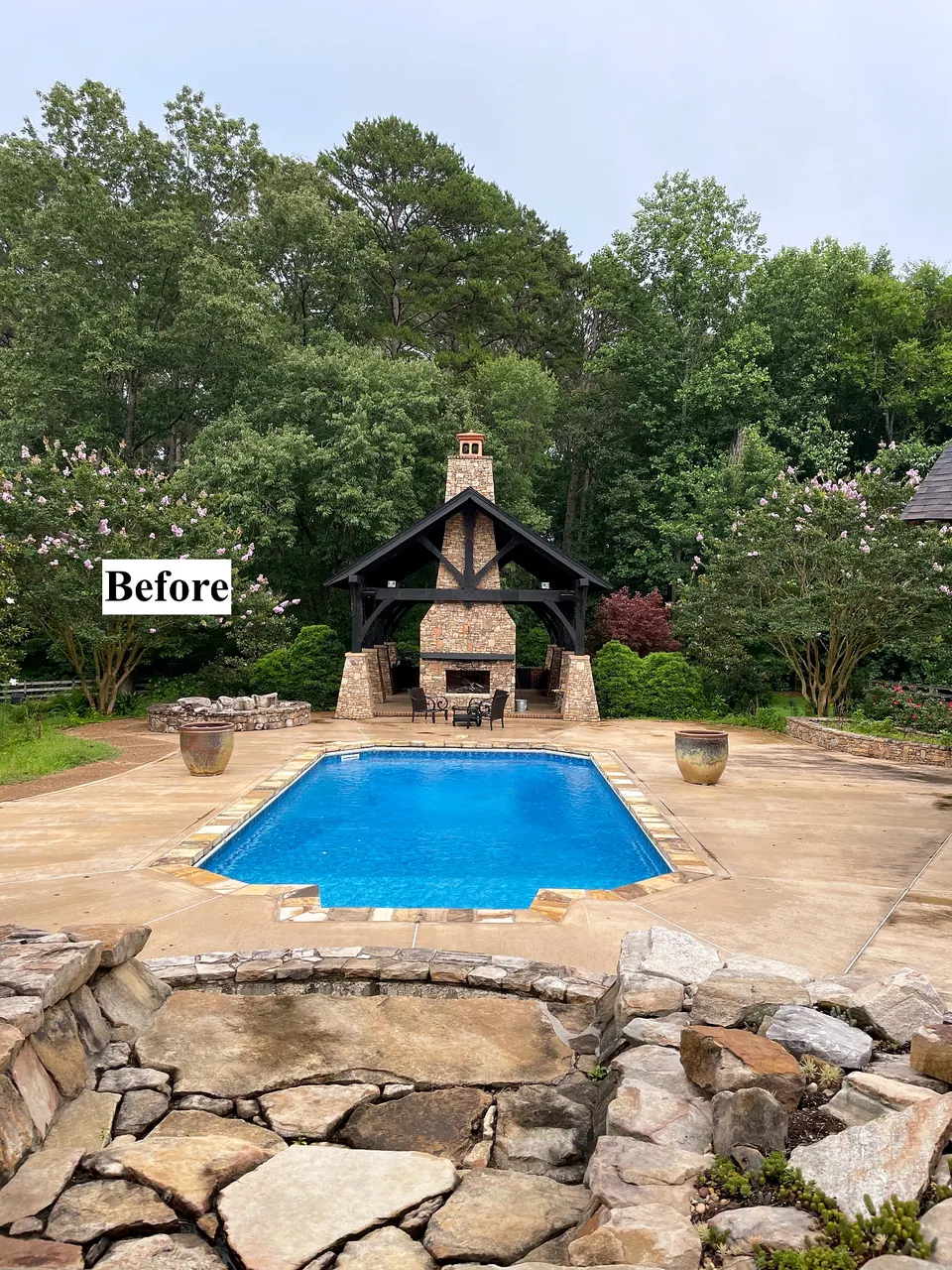 Existing swimming pool and hardscape before pool removal and site reconfiguration.