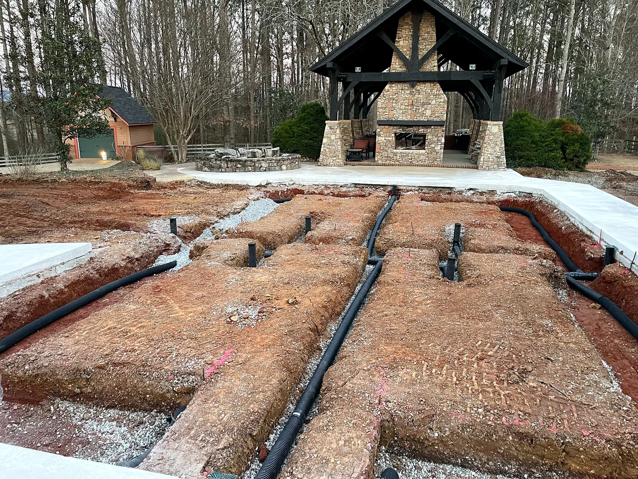Drainage and irrigation lines installed beneath the former pool area for new raised planting beds.