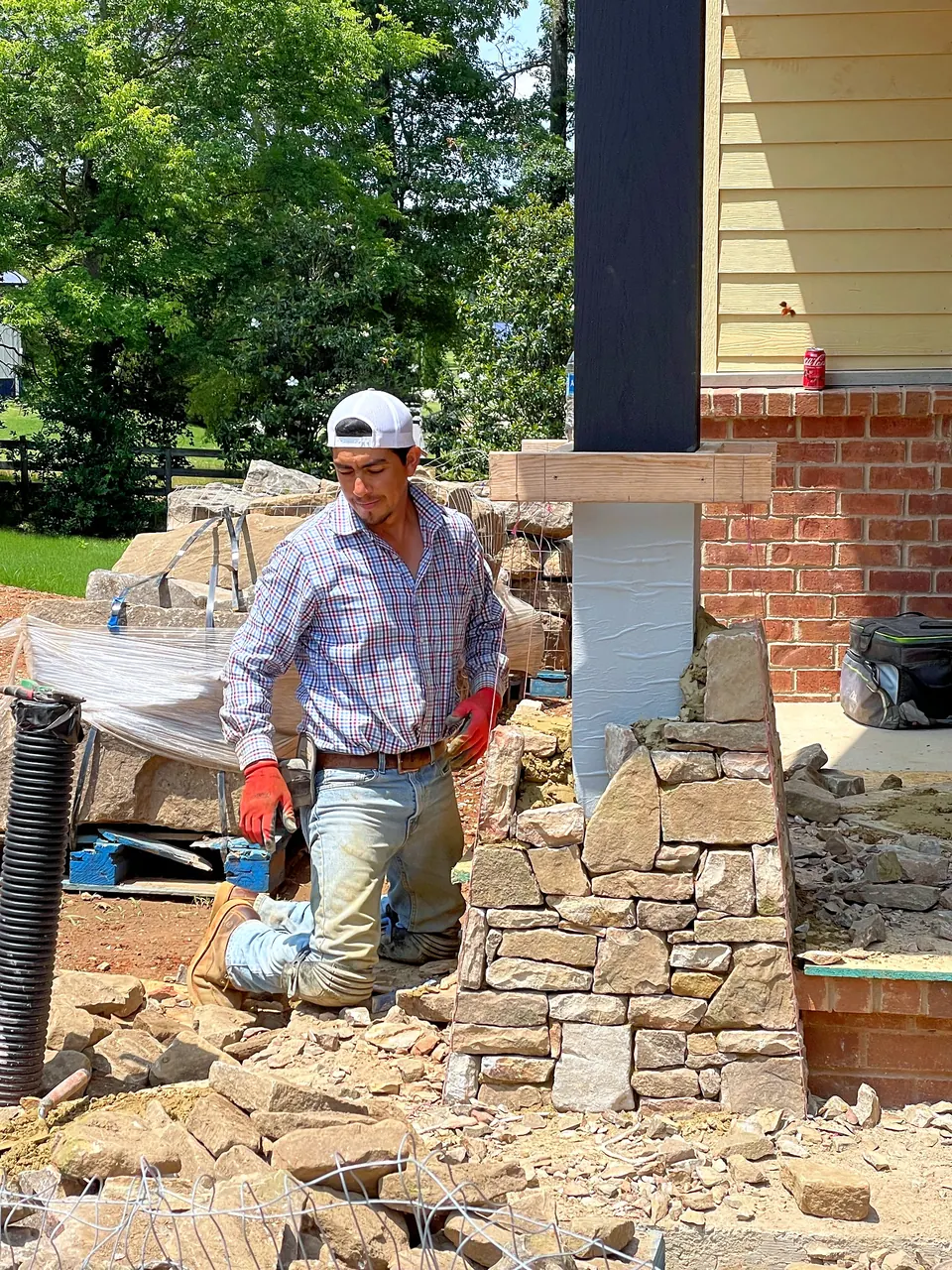 Stone column construction during a ranch house porch and hardscape project.