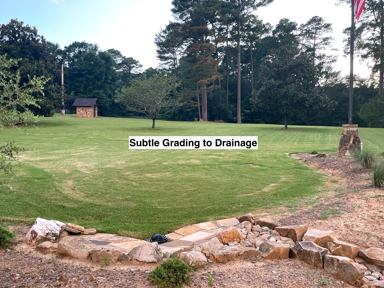 Subtle residential lawn grading designed to direct surface water toward the drainage area.