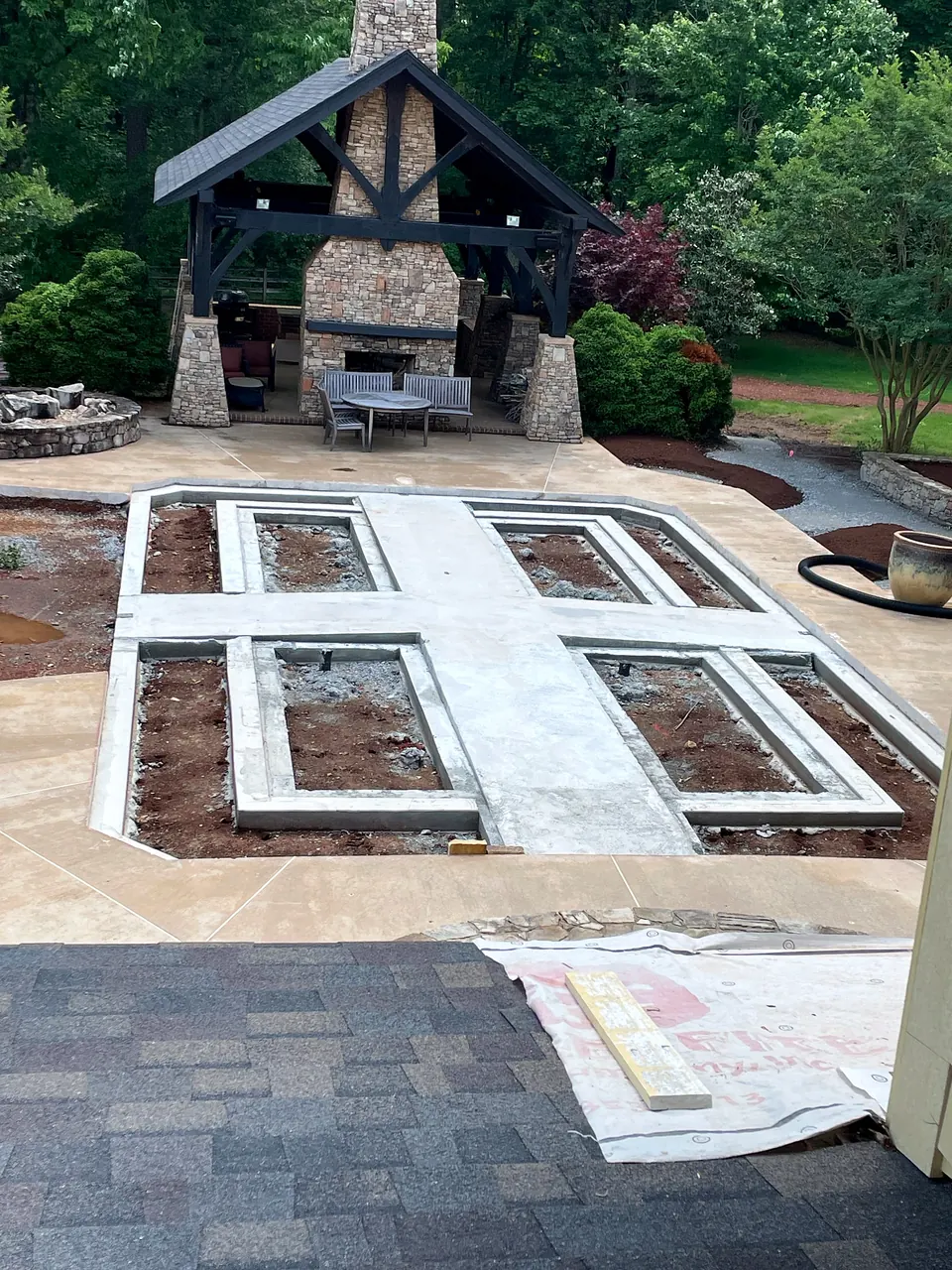New raised planting bed structures taking shape within the reconfigured hardscape.