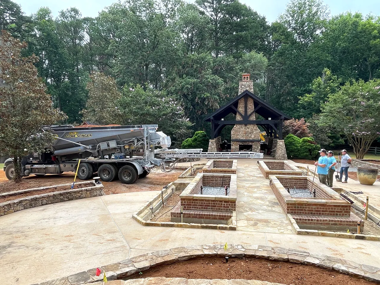 Hardscape and raised planting bed construction nearing completion after pool removal.